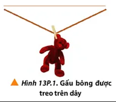 Một gấu bông được phơi trên dây treo nhẹ như Hình 13P.1 Bai 1 Trang 86 Vat Li 10 2